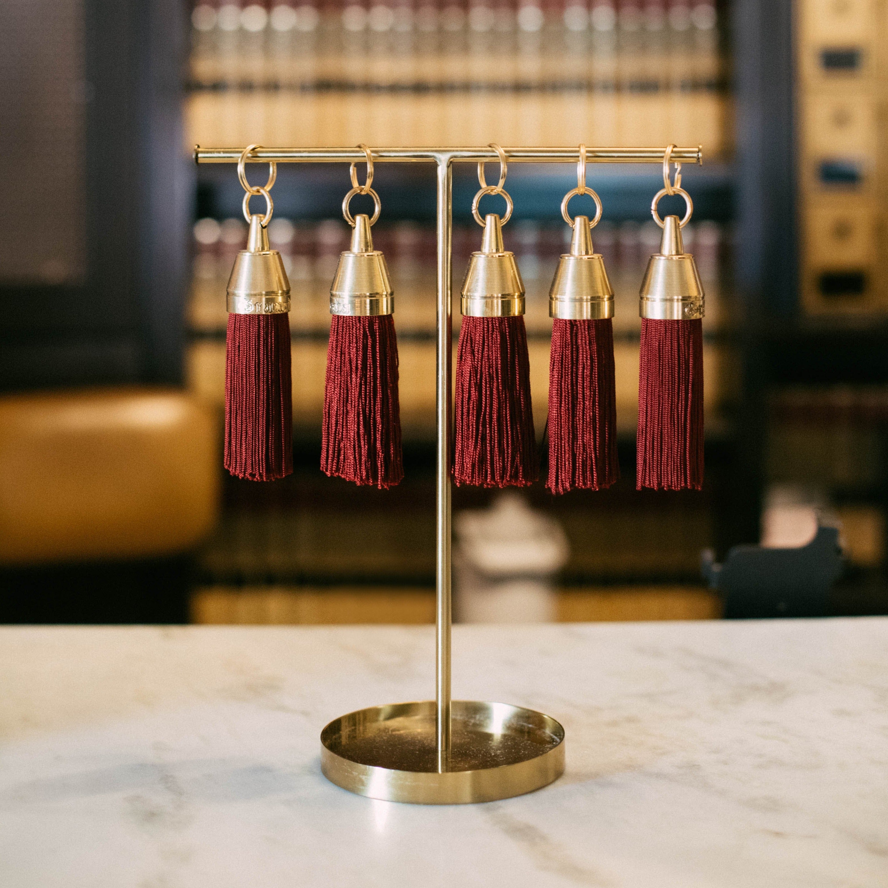 Granada Hotel Signature Tassel Keychain solid brass keychains burgundy silk tassel Nomada Signature for Granada San Luis Obispo by Nomada Deco