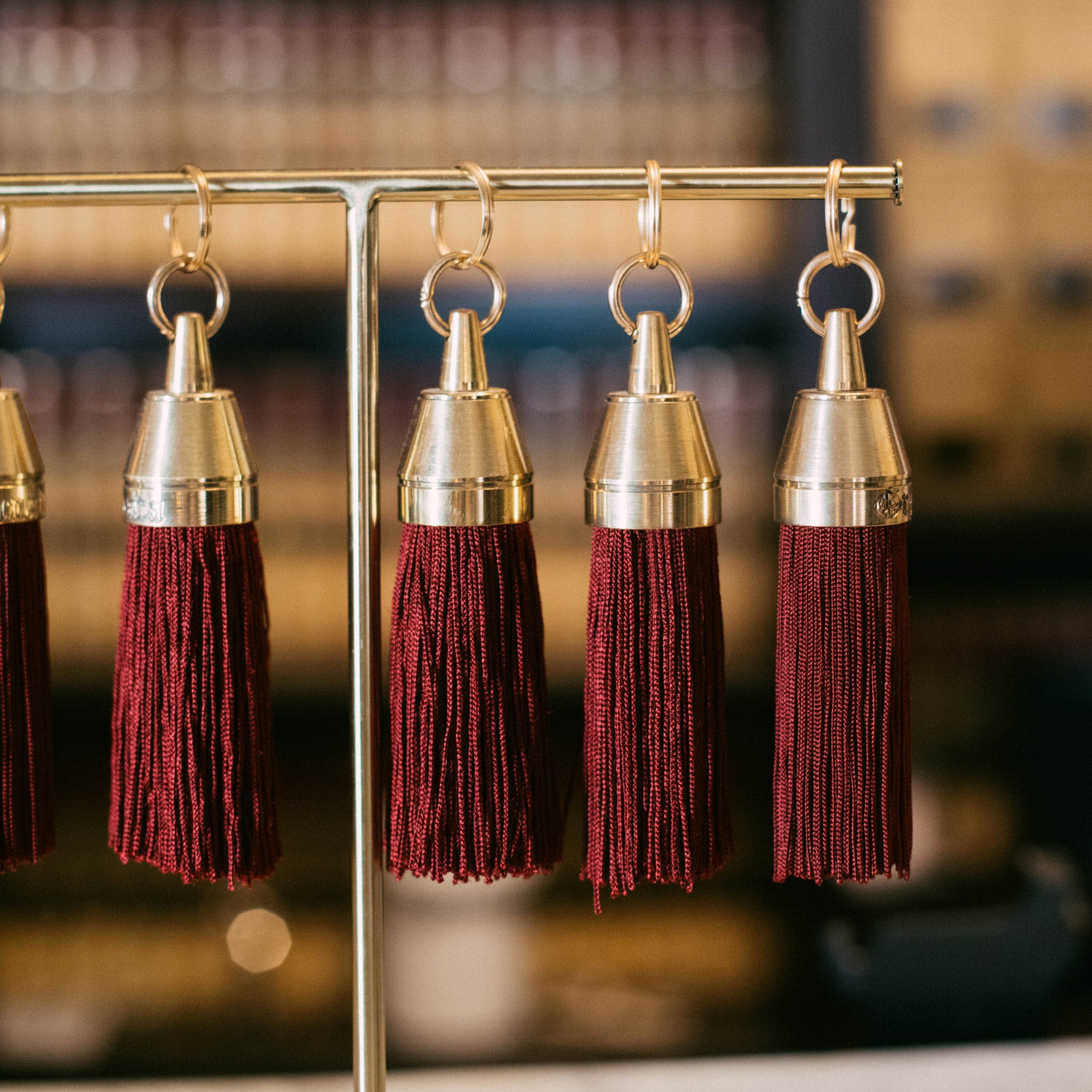 Granada Hotel Signature Tassel Keychain solid brass keychains burgundy silk tassel Nomada Signature for Granada San Luis Obispo by Nomada Deco