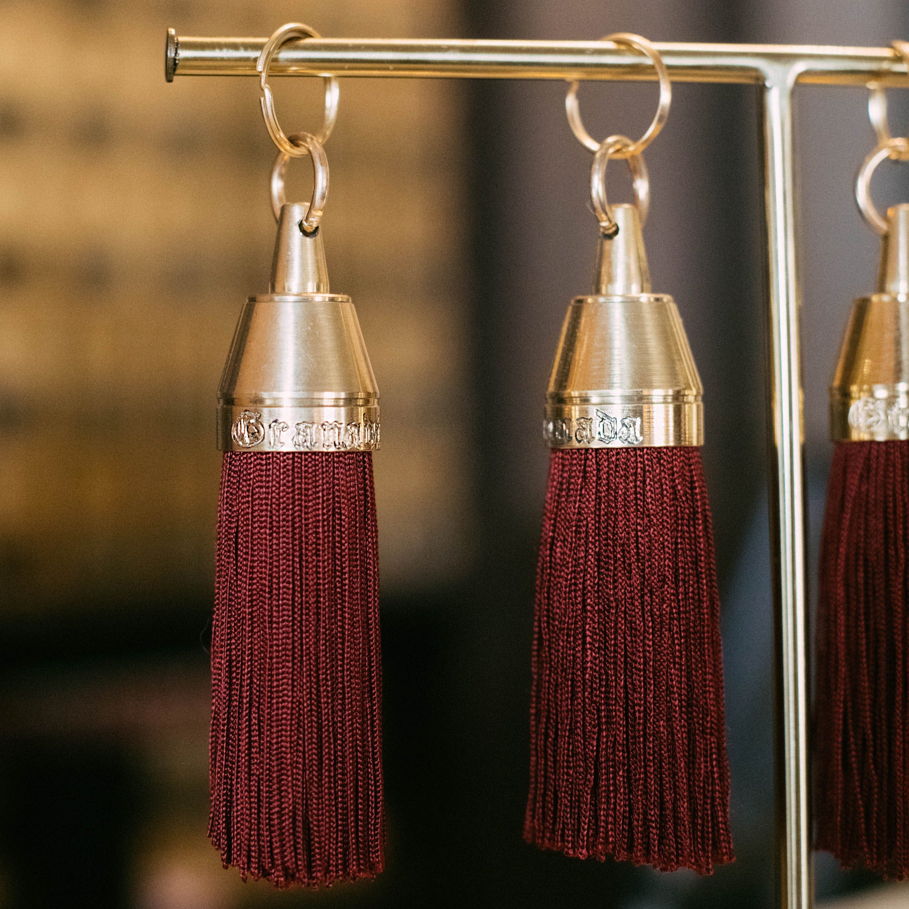 Granada Hotel Signature Tassel Keychain solid brass keychains burgundy silk tassel Nomada Signature for Granada San Luis Obispo by Nomada Deco