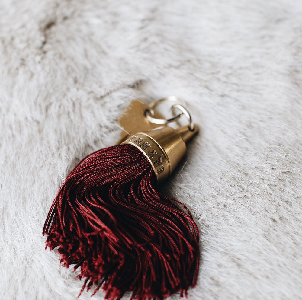 Granada Hotel Signature Tassel Keychain solid brass keychains burgundy silk tassel Nomada Signature for Granada San Luis Obispo by Nomada Deco